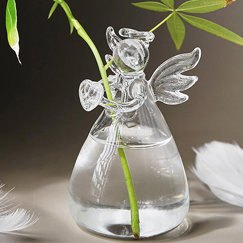 Soliflore Ange transparent en Verre présentation avec tige verte et plumes blanches.