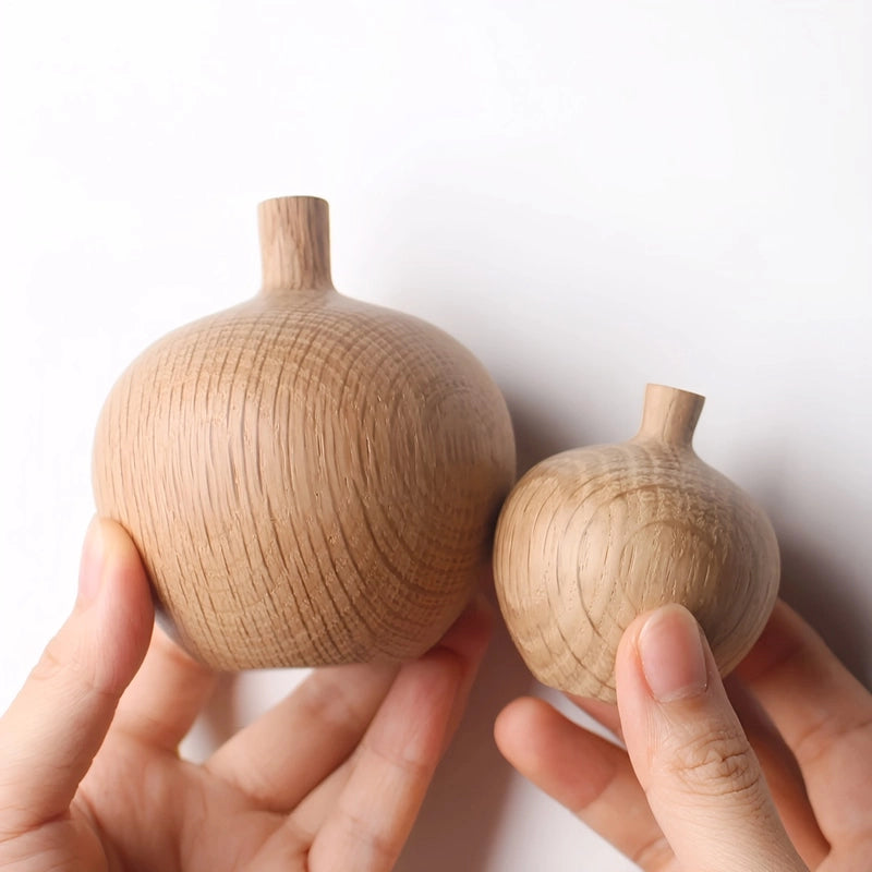 Soliflore Boule avec Col Fin en Bois, présentation des modèles B et D, tenus en main sans fleurs.