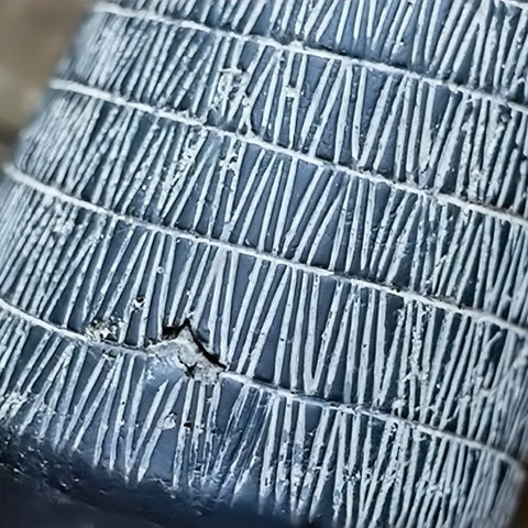 Vase d'antan gris foncé strié blanc en céramique présentation des détails strié et de la conception artisanale.