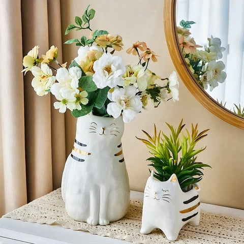 Vase blanc en forme de chat blanc en céramique avec bouquet de fleurs présentation sur meuble.