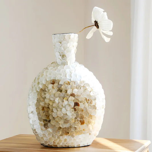 Grand Vase de Luxe Écailles Dorées, présentation avec fleur blanche sur un meuble en bois.
