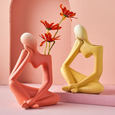 Vase soliflore design figurine pensive présentation modèle rouge brique avec fleurs rouge