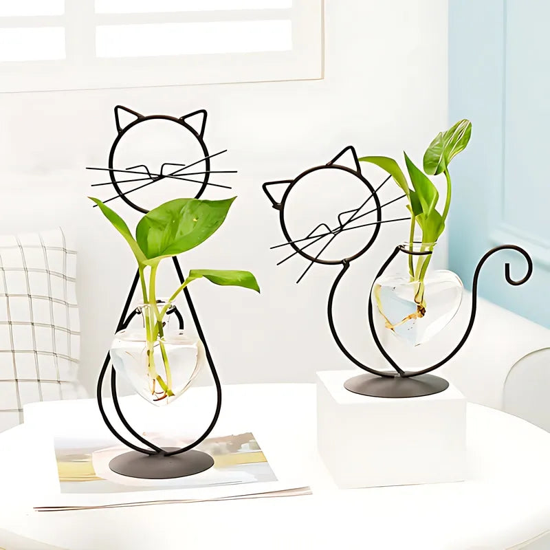 Soliflore Petit Chat Cœur Craquant présentation des modèles noirs 19 cm et 28 cm sur une table blanche avec plantes vertes.