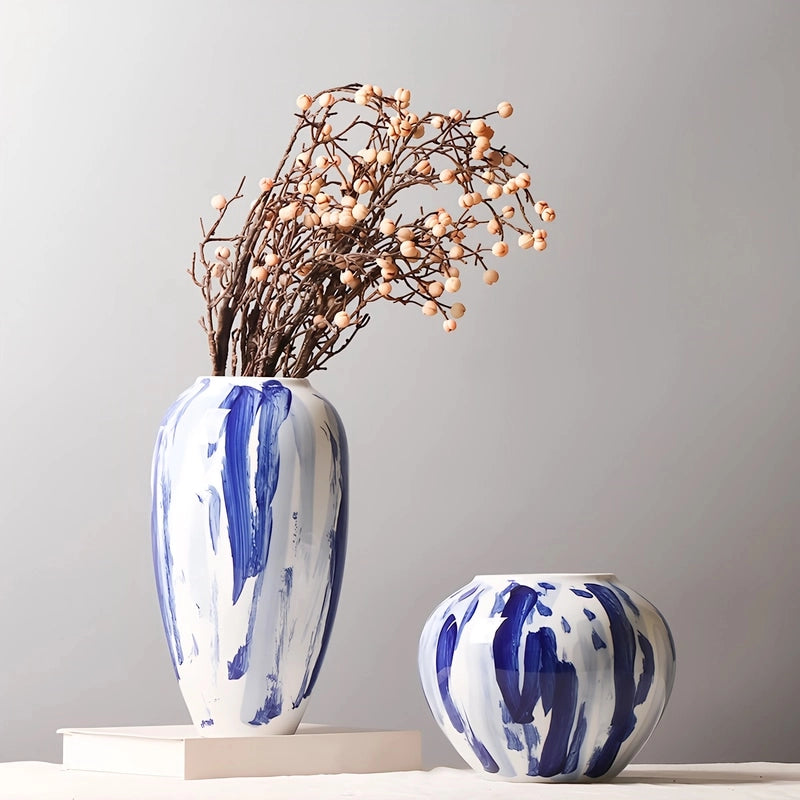 Vase Artistique Blanc aux Motifs Bleus Peint à la Main présentation des modèles B avec fleurs séchées et D sans fleurs sur une table.