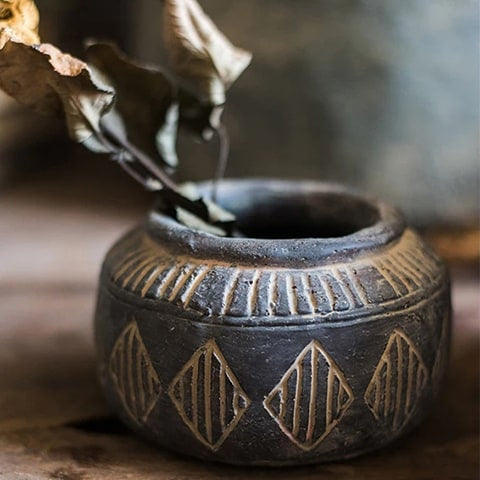 Vase pot style art ancien motifs losanges modèle S présentation sur une table avec tige de feuilles séchées